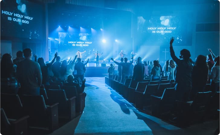 Crowd raising hands during worship event