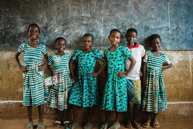 a group of girls wearing green dresses in school