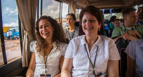 women riding on a bus laughing