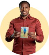 Martin, a Compassion alumni, wears a red dress shirt. He holds a picture of him when he was a sponsored child and smiles. He is framed by a yellow circle