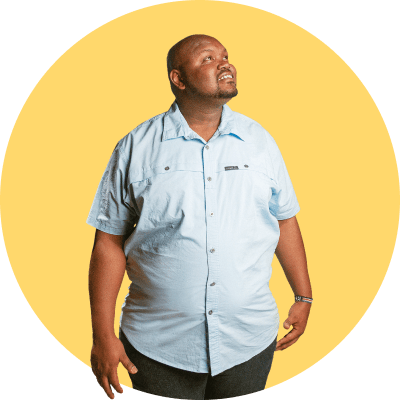 Owen, a Compassion Alumni, stands and looks up to the sky.